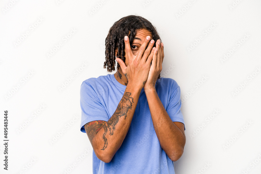 Young African American man isolated on white background blink through fingers frightened and nervous. Young African American man isolated on white background blink through fingers frightened and nervous.