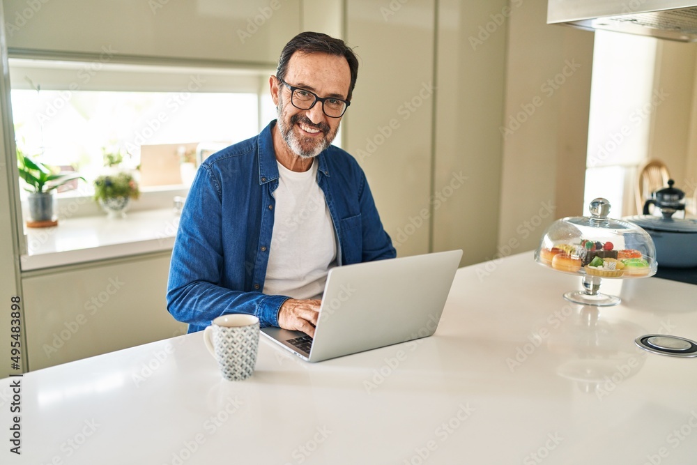 Middle age man smiling confident using laptop at home Middle age man smiling confident using laptop at home