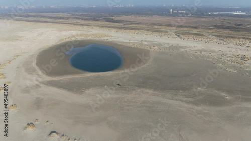 Aerial video of the dutch coastal defence project sand engine where natural forces divide sediment along the coast  photo