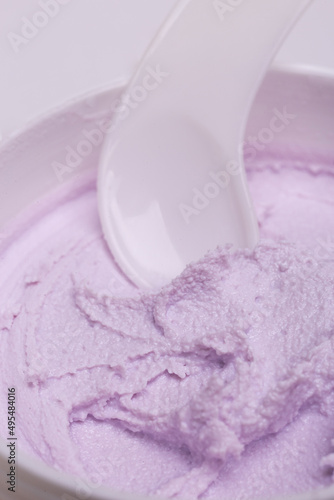 White jar of pink textured cream close-up