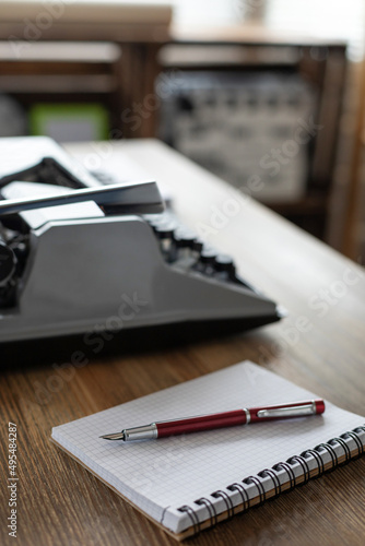 Notebook and vintage old typewriter on desk table