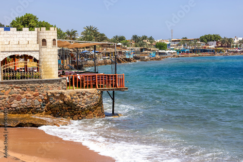 Red Sea coast, view of the sandy beach and the boulevard with restaurants and hotels, Dahab, Egypt