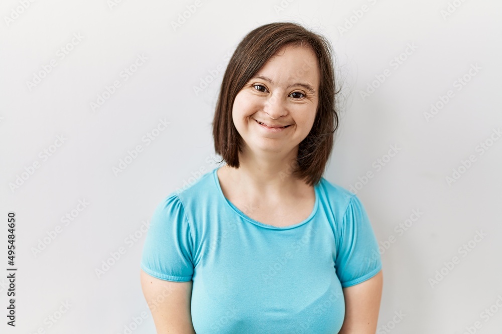 Young down syndrome woman standing over isolated background with a happy and cool smile on face. lucky person. Young down syndrome woman standing over isolated background with a happy and cool smile on face. lucky person.