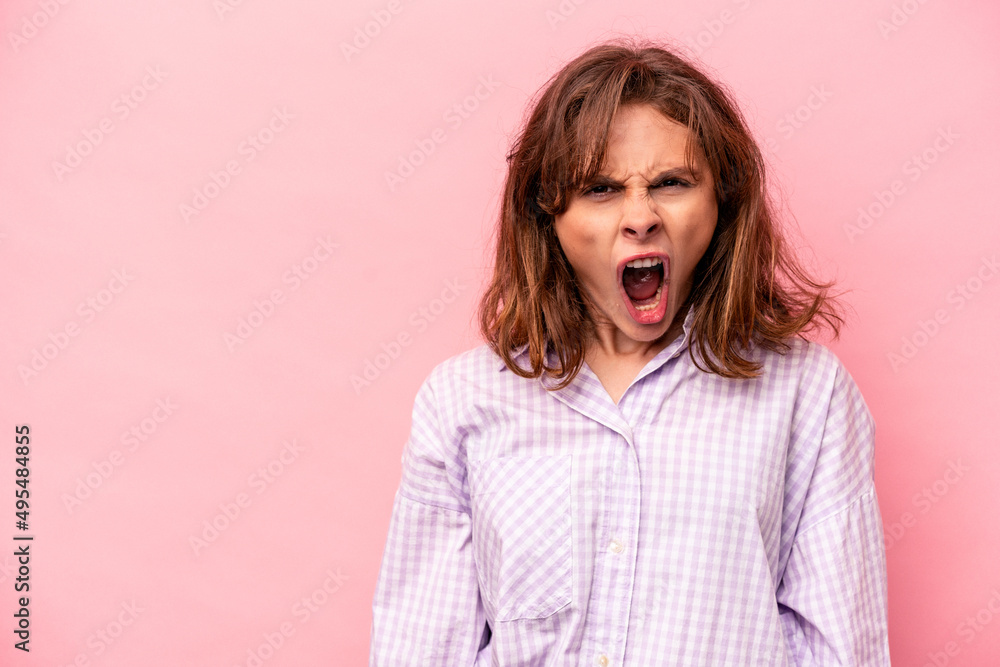Young caucasian woman isolated on pink background shouting very angry, rage concept, frustrated. Young caucasian woman isolated on pink background shouting very angry, rage concept, frustrated.