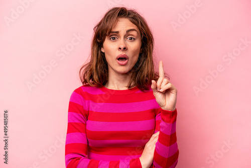 Young caucasian woman isolated on pink background having some great idea, concept of creativity.