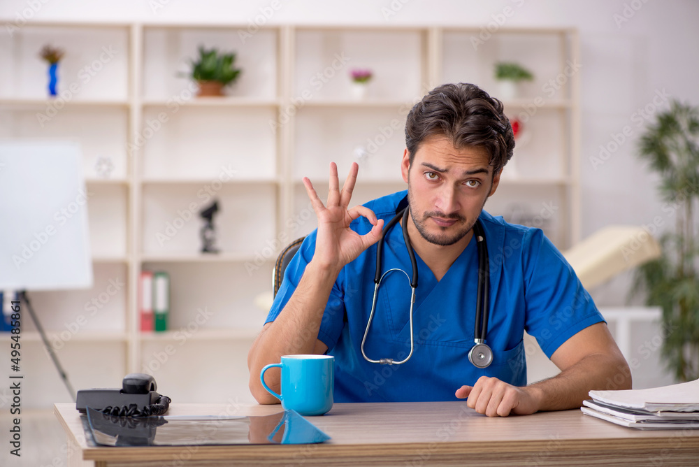 Young male doctor working in the clinic Young male doctor working in the clinic
