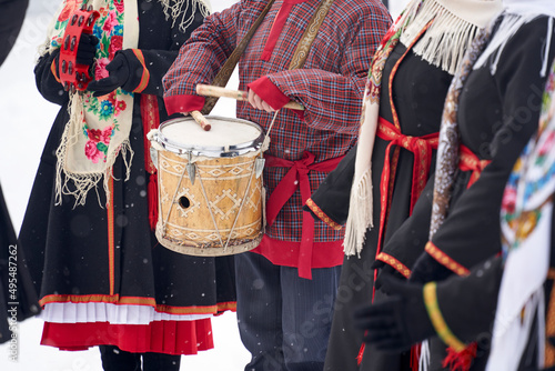  playing the drums in close-up in national costumes