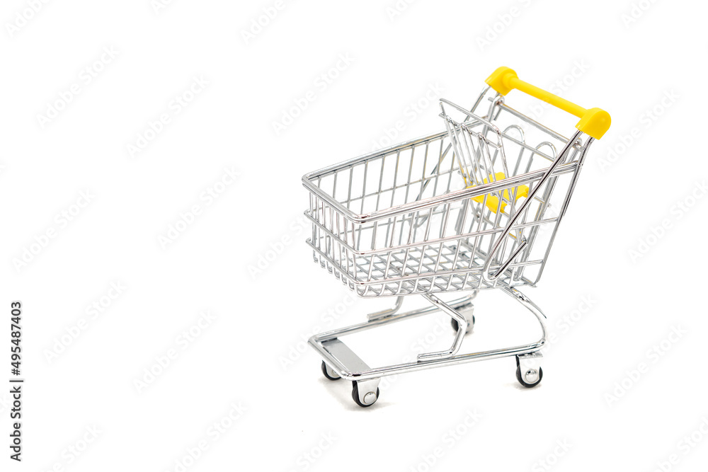 Small empty shopping cart on white background. Selective focus. Small empty shopping cart on white background. Selective focus.