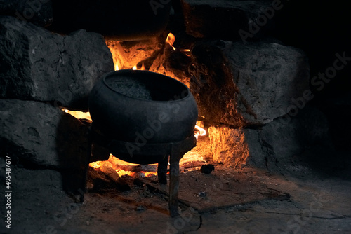  a burning hearth in the house and a cooking pot