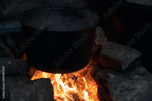  a burning hearth in the house and a cooking pot
