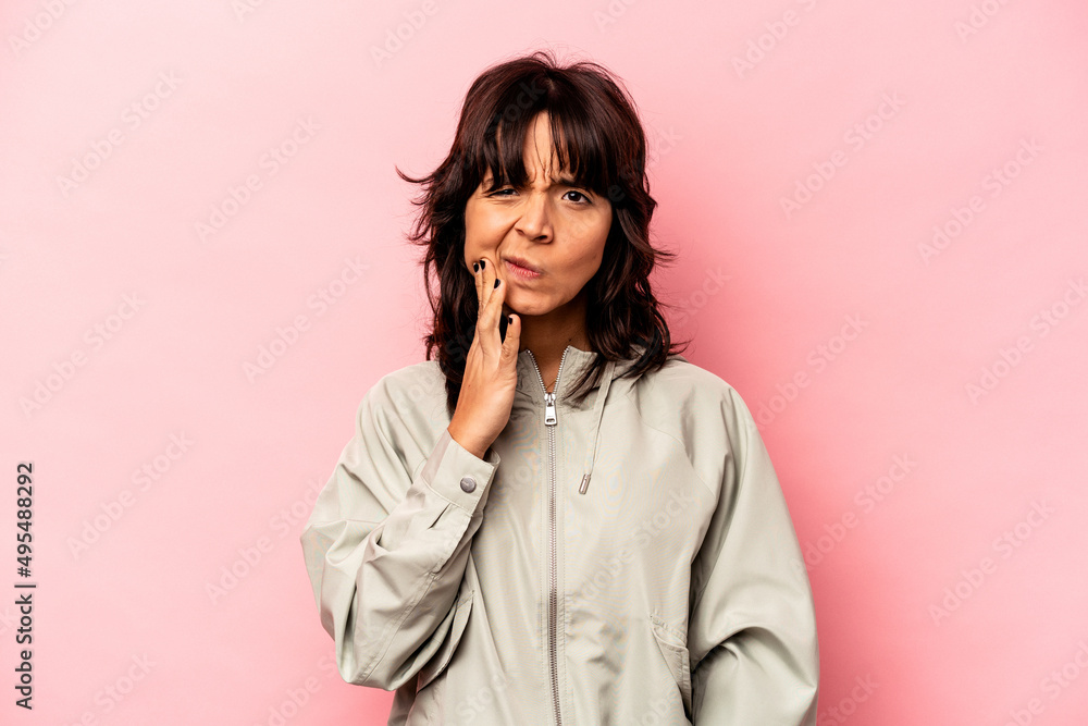 Young hispanic woman isolated on pink background having a strong teeth pain, molar ache. Young hispanic woman isolated on pink background having a strong teeth pain, molar ache.