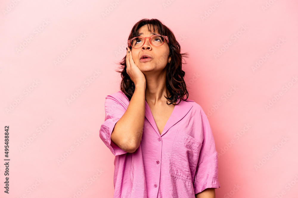 Young hispanic woman isolated on pink background tired and very sleepy keeping hand on head. Young hispanic woman isolated on pink background tired and very sleepy keeping hand on head.
