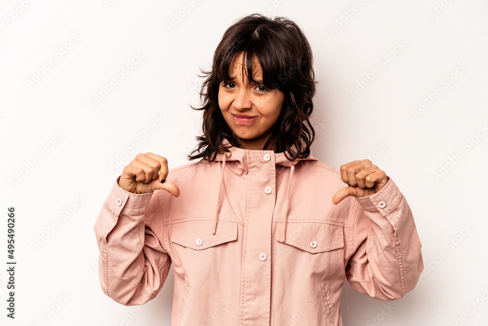 Young hispanic woman isolated on white background showing thumb down, disappointment concept. Young hispanic woman isolated on white background showing thumb down, disappointment concept.