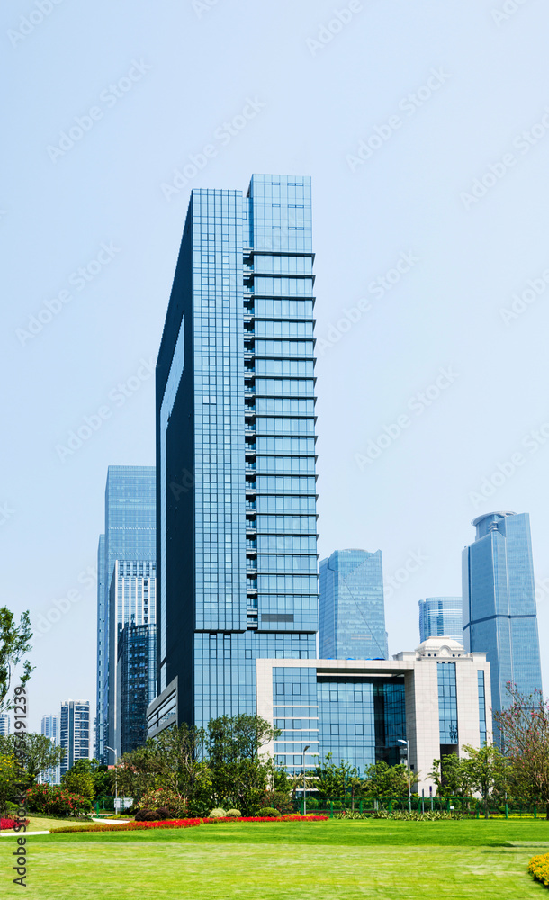 Green park next to business center buildings