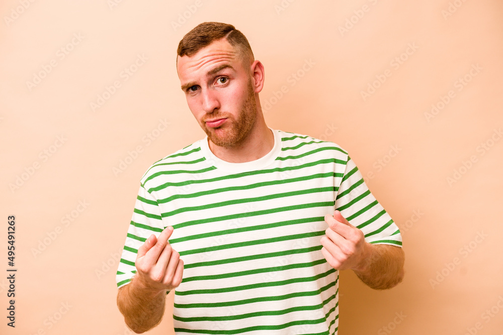 Young caucasian man isolated on beige background showing that she has no money. Young caucasian man isolated on beige background showing that she has no money.