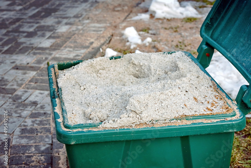 Open salt container, salt for slippery surface closeup, grit salt bin. Container with rock salt mixture used in cold season to sprinkle sidewalks, ice melt, slippery prevention. Melting snow and ice © Tricky Shark
