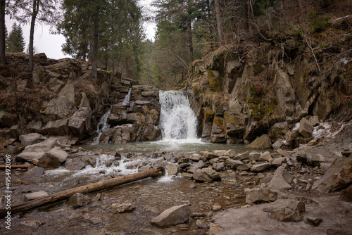 Pieniny National Park in Carpathian Mountains, Poland - 03.27.2022 - Sunny day with nice view on waterfall feeding a pool (Zaskalnik) in Szczawnica. photo