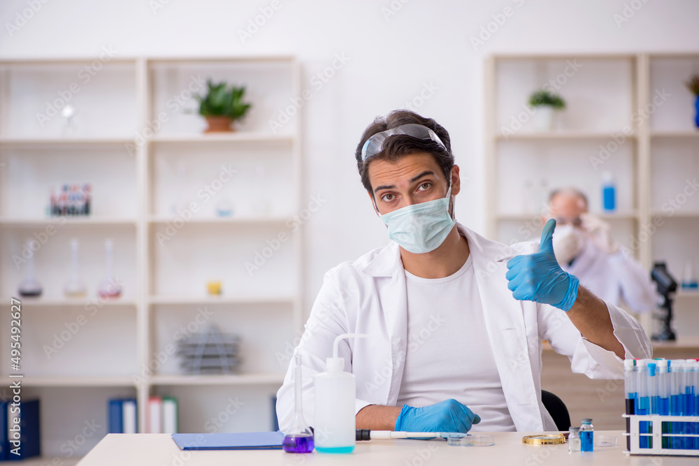 Two male chemist working at the lab Two male chemist working at the lab