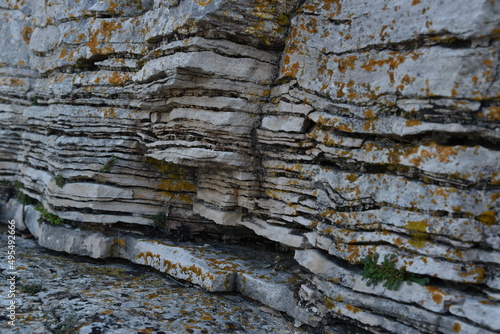 Textured surfaces of rusted layer of rock. Sedimentary rocks layered close-up, texture background.
