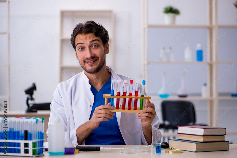 Young male chemist working at the lab Young male chemist working at the lab