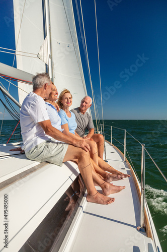 Retired friends enjoying luxury lifestyle sailing private yacht © Spotmatik