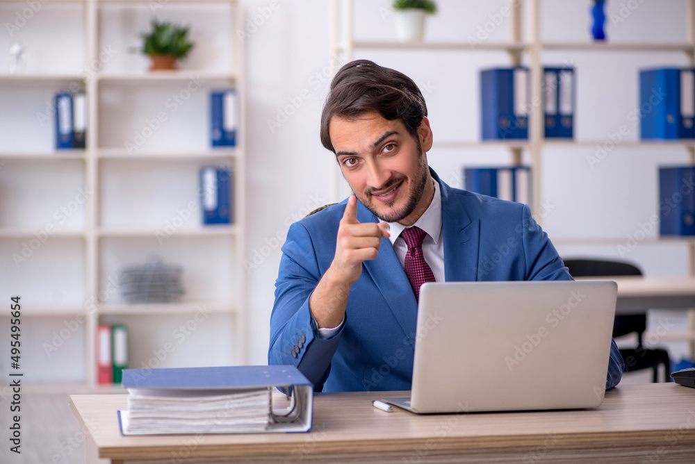 Fototapeta premium Young male employee and too much work in the office