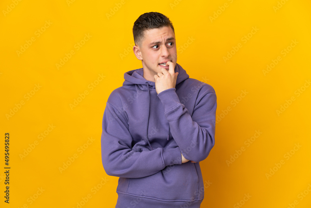 Young caucasian man isolated on yellow background nervous and scared Young caucasian man isolated on yellow background nervous and scared