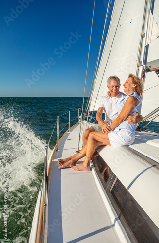 Retired American couple laughing together on luxury yacht