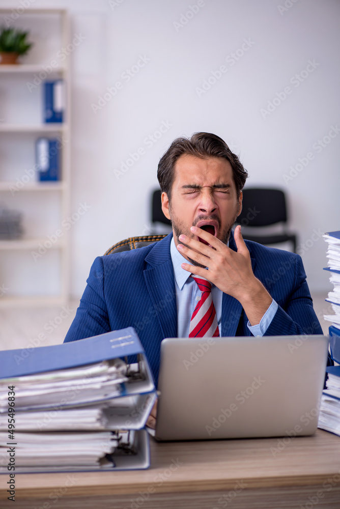 Fototapeta premium Young male employee and too much work in the office