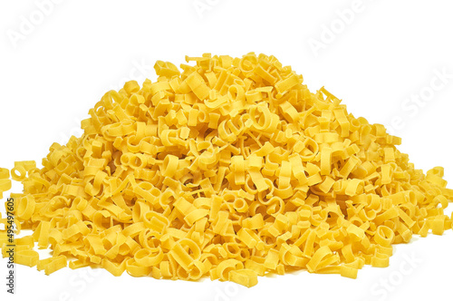 Heap of dry pasta in the form of an alphabet on a white background