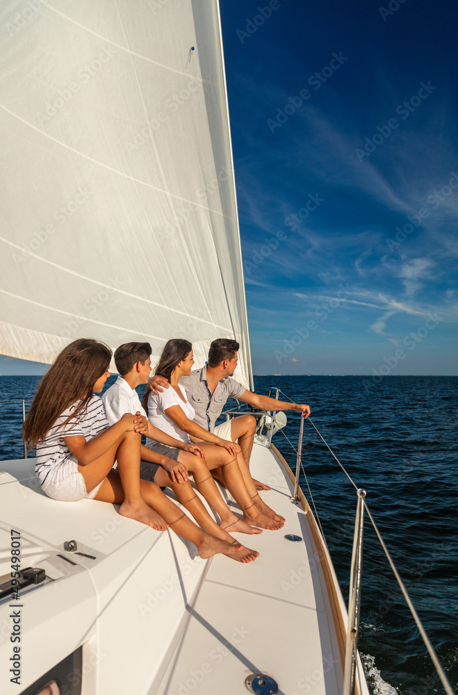 Latino family enjoying carefree lifestyle sailing the ocean