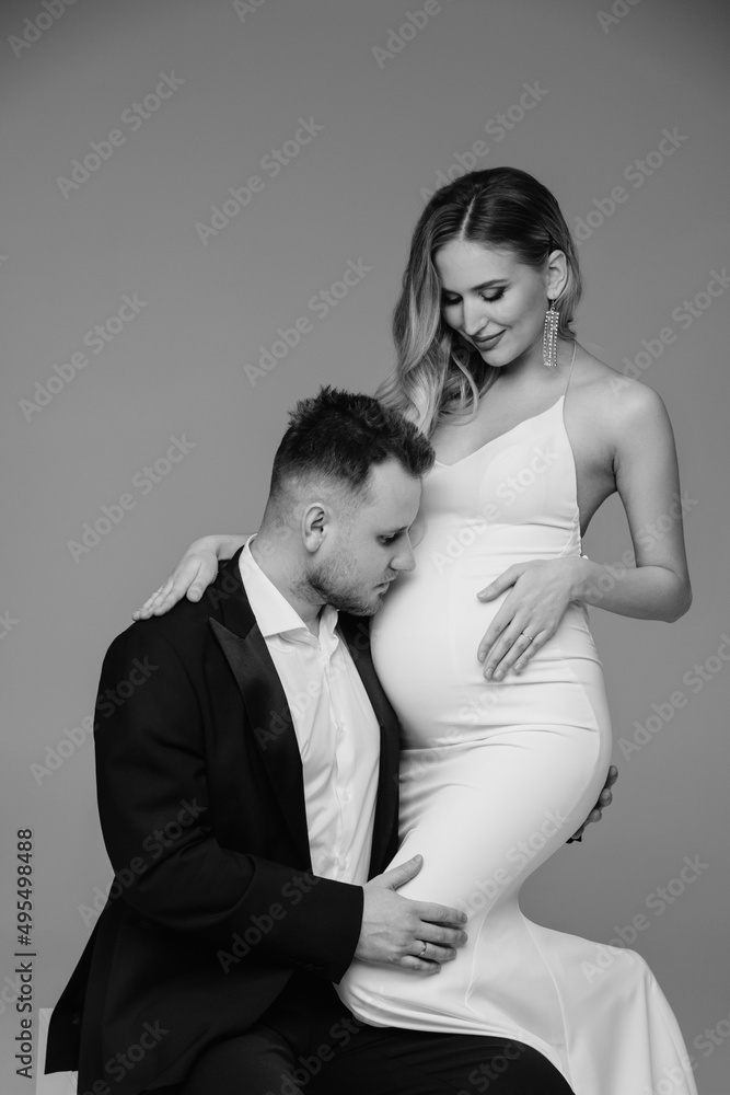 Couple studio intimate portrait. Man hugging his pregnant woman. Couple studio intimate portrait. Man hugging his pregnant woman.
