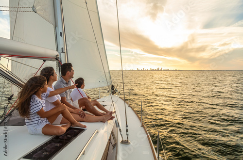 Family sailing vacation at sunset on luxury yacht © Spotmatik