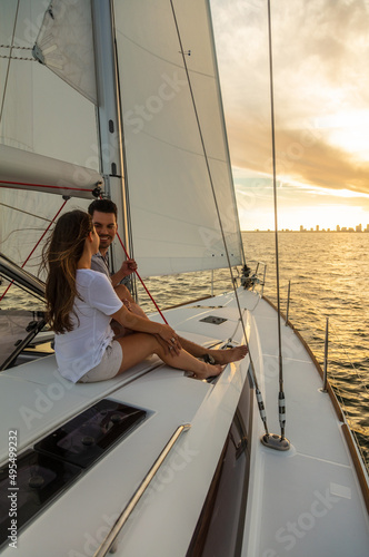 Hispanic couple enjoying romantic getaway on private yacht