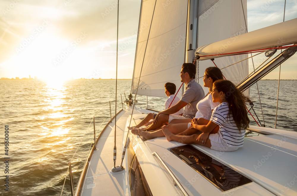 Family travel adventures on luxury yacht at sunset - obrazy, fototapety, plakaty 