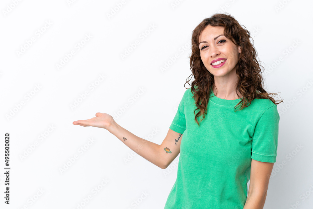Young woman with curly hair isolated on white background extending hands to the side for inviting to come Young woman with curly hair isolated on white background extending hands to the side for inviting to come