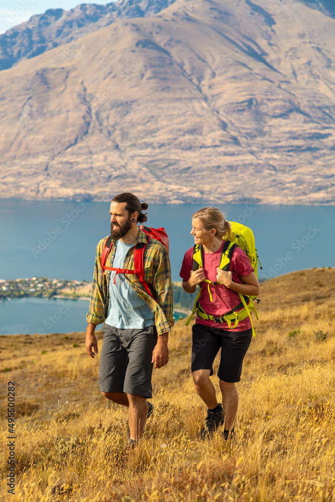 New Zealand Male female hikers trekking The Remarkables New Zealand Male female hikers trekking The Remarkables