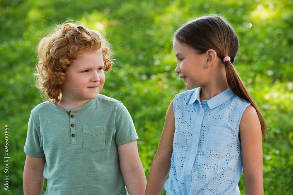 positive girl and boy looking at each other outdoors. positive girl and boy looking at each other outdoors.