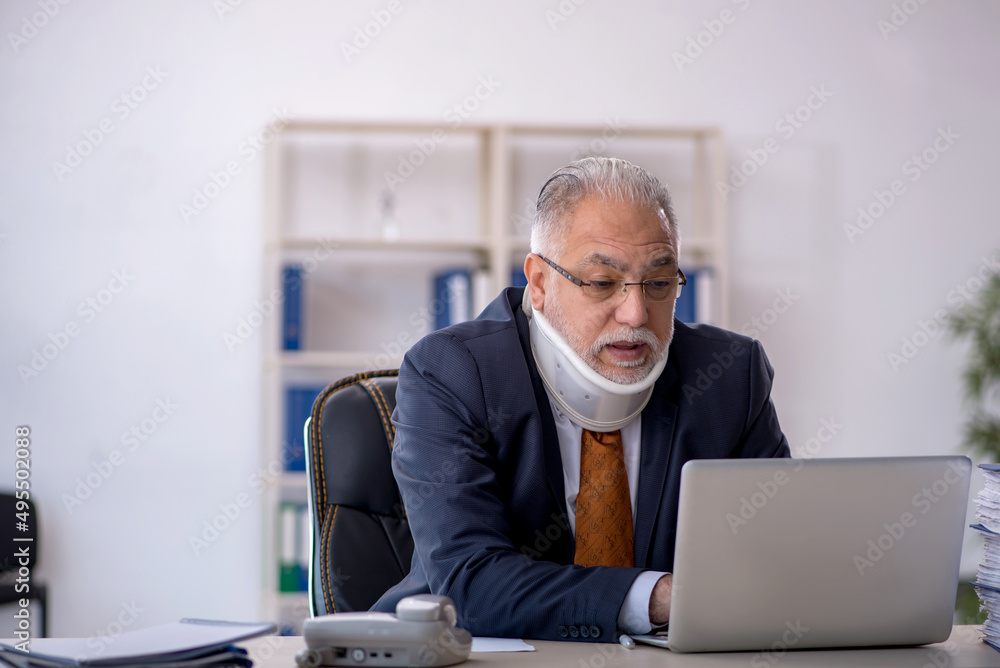Old male employee after accident at workplace Old male employee after accident at workplace