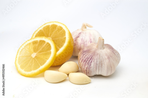 Isolated gremolata sauce ingredients. Whole lemon fruit, segment of fresh garlic and parsley leaf isolated on white background