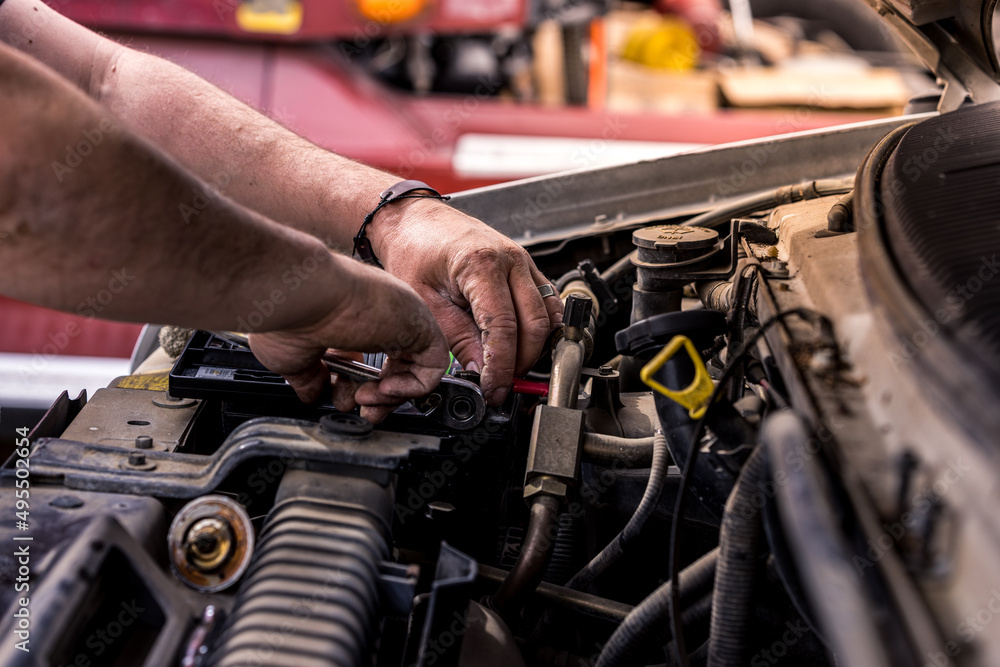 Mechanic with dirty hands works on car engine. Authentic shot of real auto mechanic working on motor. Mechanic with dirty hands works on car engine. Authentic shot of real auto mechanic working on motor.