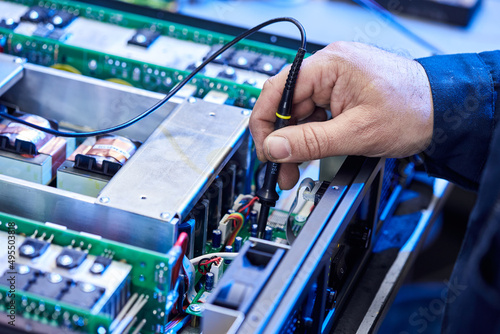 Repairing Hardware Equipment. Repair Shop and Worker with Tools.  Microchip and Circuit Board. Testing Modern Digital Device on Desk . Electronic Devices Concept. © bondvit