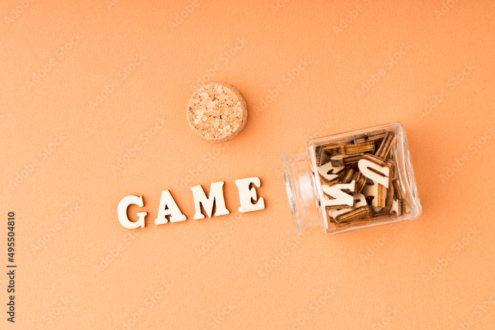 game word from wooden letters on orange background game word from wooden letters on orange background