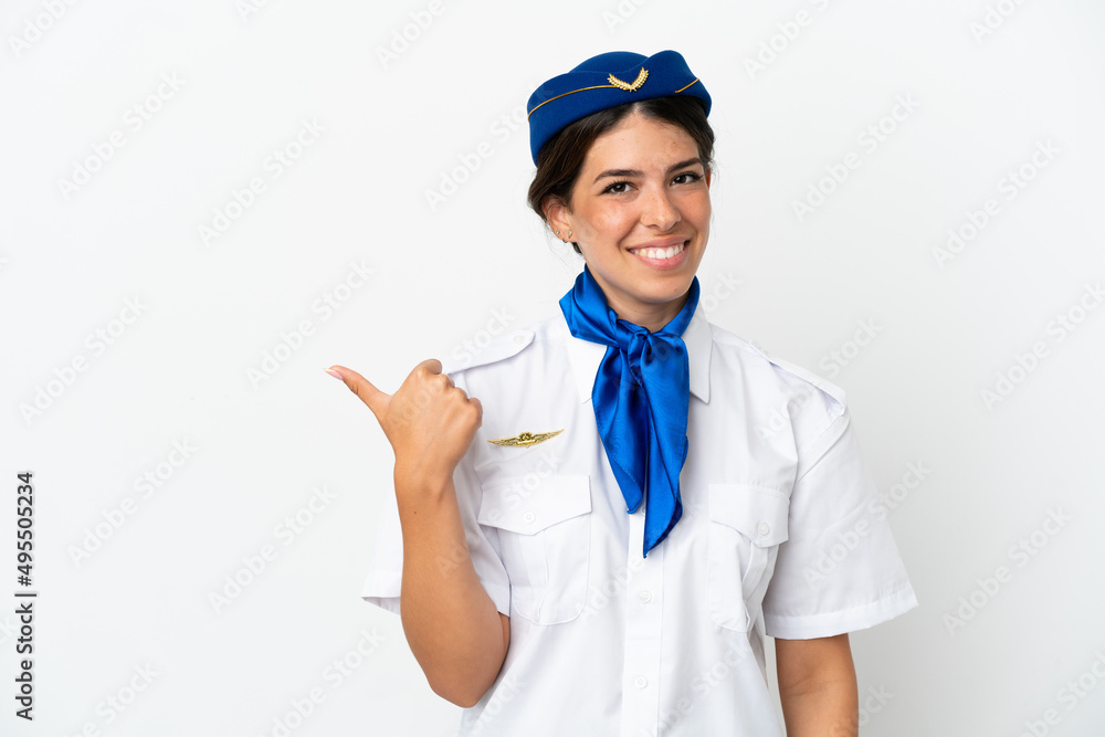 Airplane stewardess caucasian woman isolated on white background pointing to the side to present a product Airplane stewardess caucasian woman isolated on white background pointing to the side to present a product