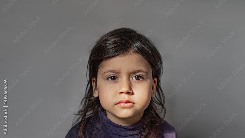 Close-up portrait of a charming 3 year old girl. The child looks sadly at the camera. Asian girl with dark eyes and hair Close-up portrait of a charming 3 year old girl. The child looks sadly at the camera. Asian girl with dark eyes and hair