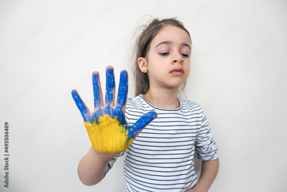 Child's hands painted on Ukraine flag colors. Child's hands painted on Ukraine flag colors.