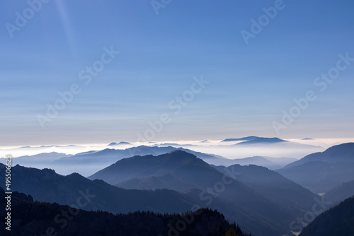 A panoramic view on the mountain peaks of the Hochschwab Region in Upper Styria  Austria. Cloudless weather on a sunny summer day in the Alps. Blue misty valley and soft hills. Concept freedom