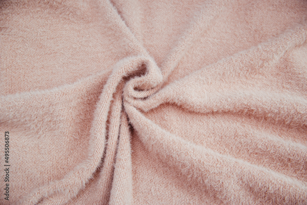 Pink fluffy fabric for drapery. A piece of warm cloth with folds. Pink fluffy fabric for drapery. A piece of warm cloth with folds.