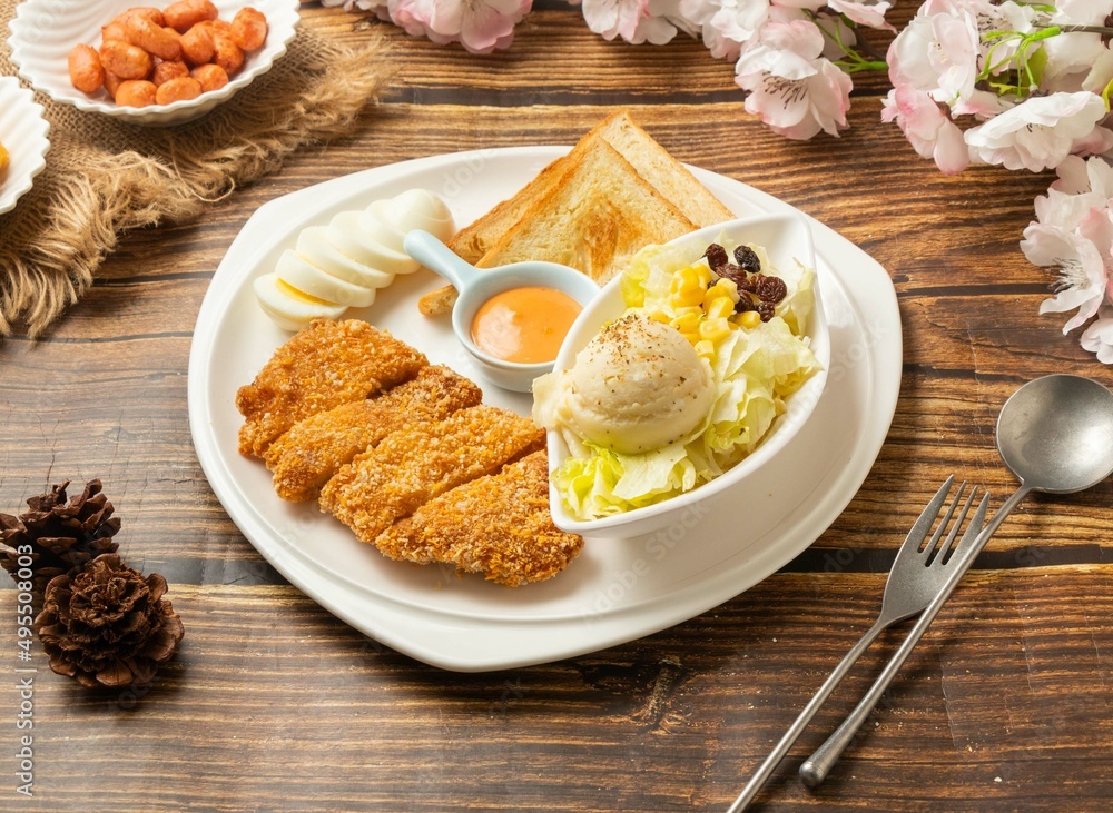Chicken Cutlet Platter in dish side view on wooden table taiwan style food Chicken Cutlet Platter in dish side view on wooden table taiwan style food