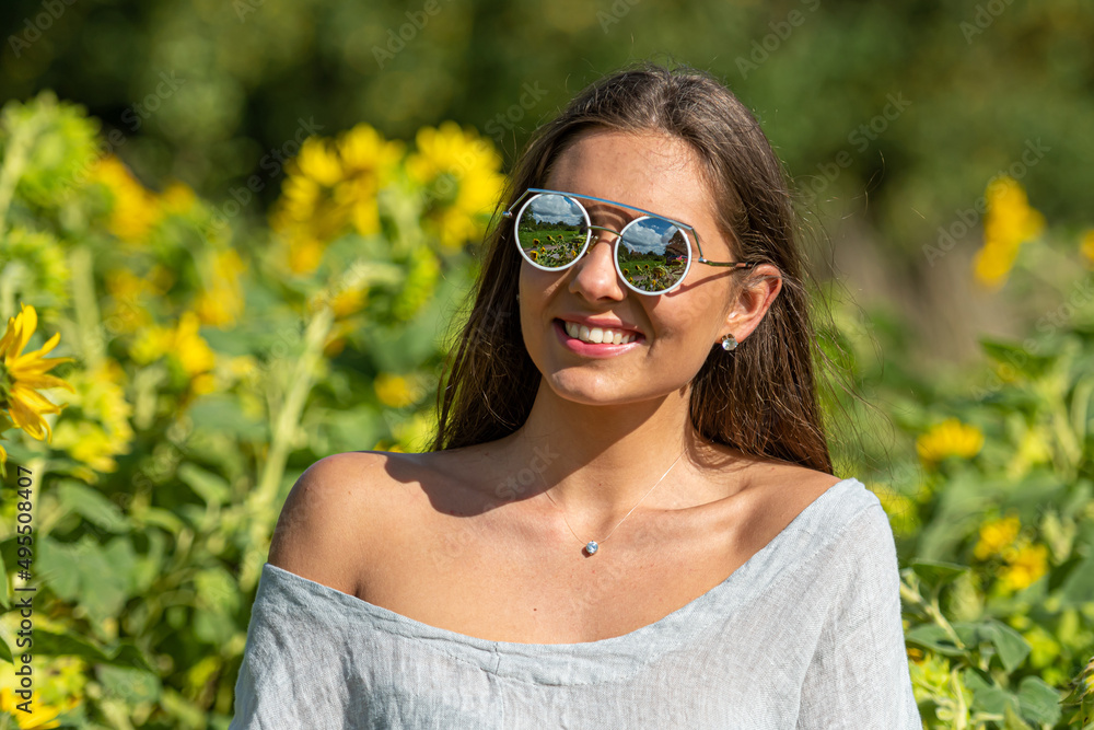 pretty sensual young brunette in sunglasses in a field of blooming sunflowers, young woman portrait pretty sensual young brunette in sunglasses in a field of blooming sunflowers, young woman portrait